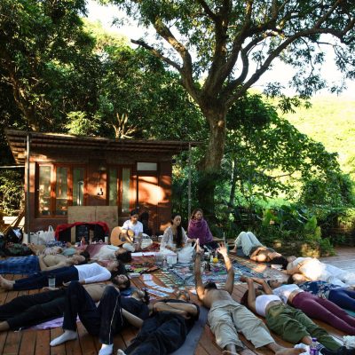 Mantra Blessing Night event poster by Miraclevie Sound Healing, featuring a woman meditating with a glowing lotus flower on a blue background.