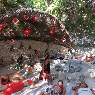 A professional set of frosted crystal singing bowls and candles in a warm, dimly lit healing studio.